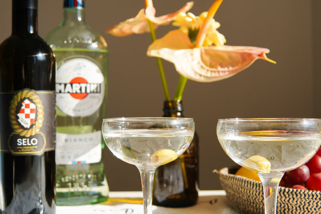 Elegant martini glass on a kitchen table, delicately drizzled with Selo Croatian olive oil.